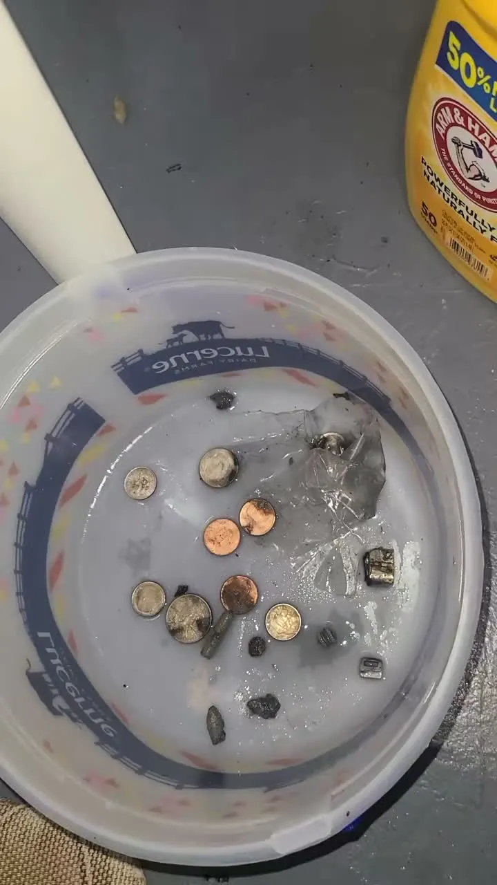 Coins and debris removed from a Whirlpool washer drain pump